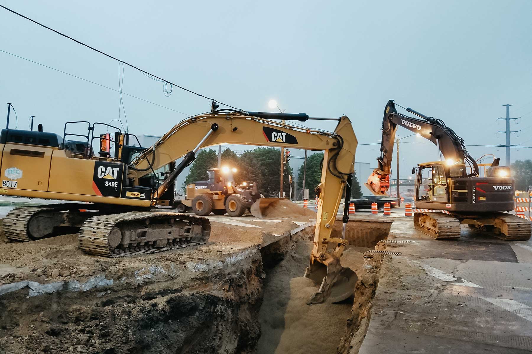 excavators digging on a road